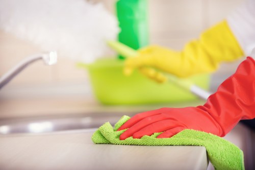 A worker following health and safety practices during carpet cleaning